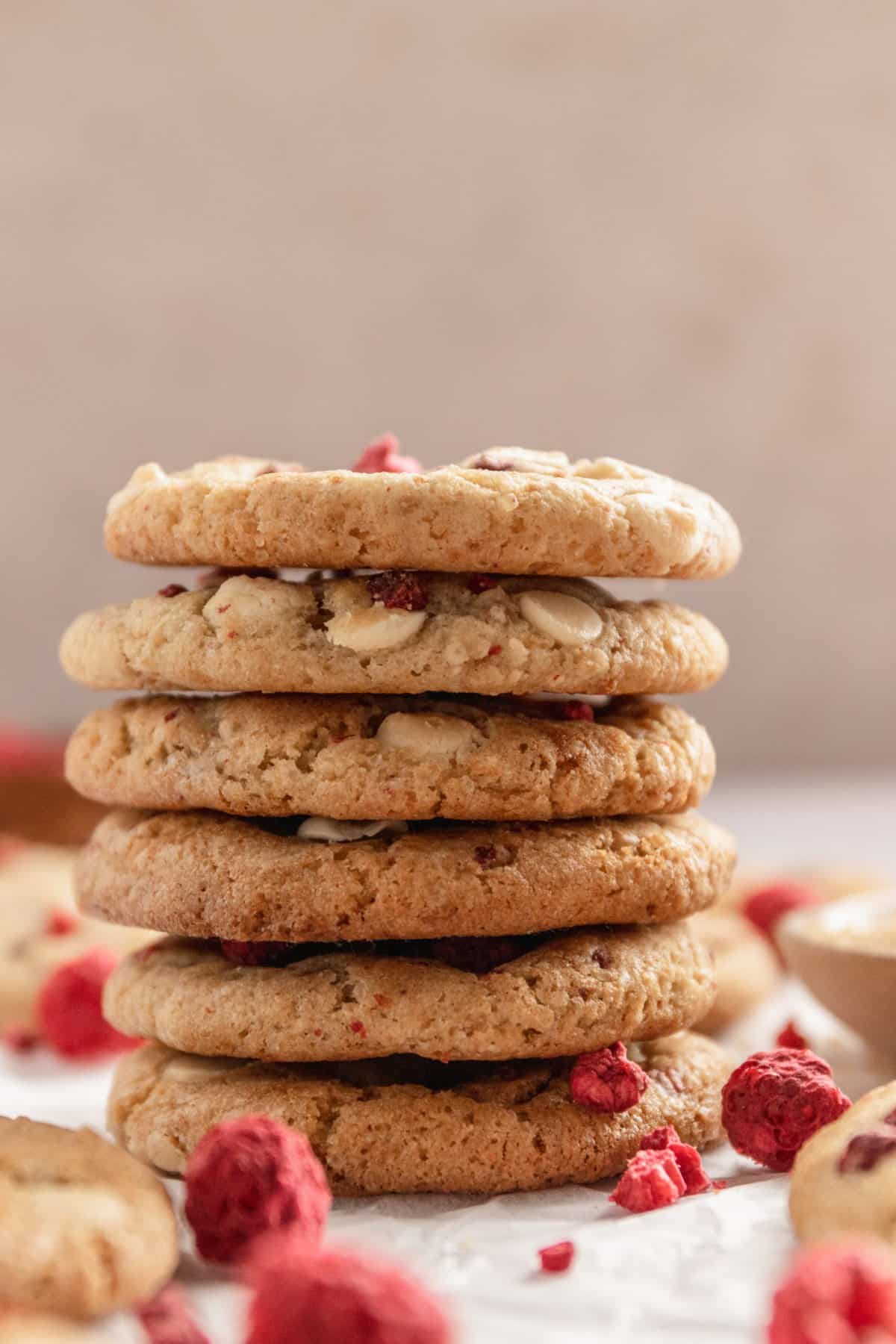 Cookies stacked on top of each other with a beige background. 
