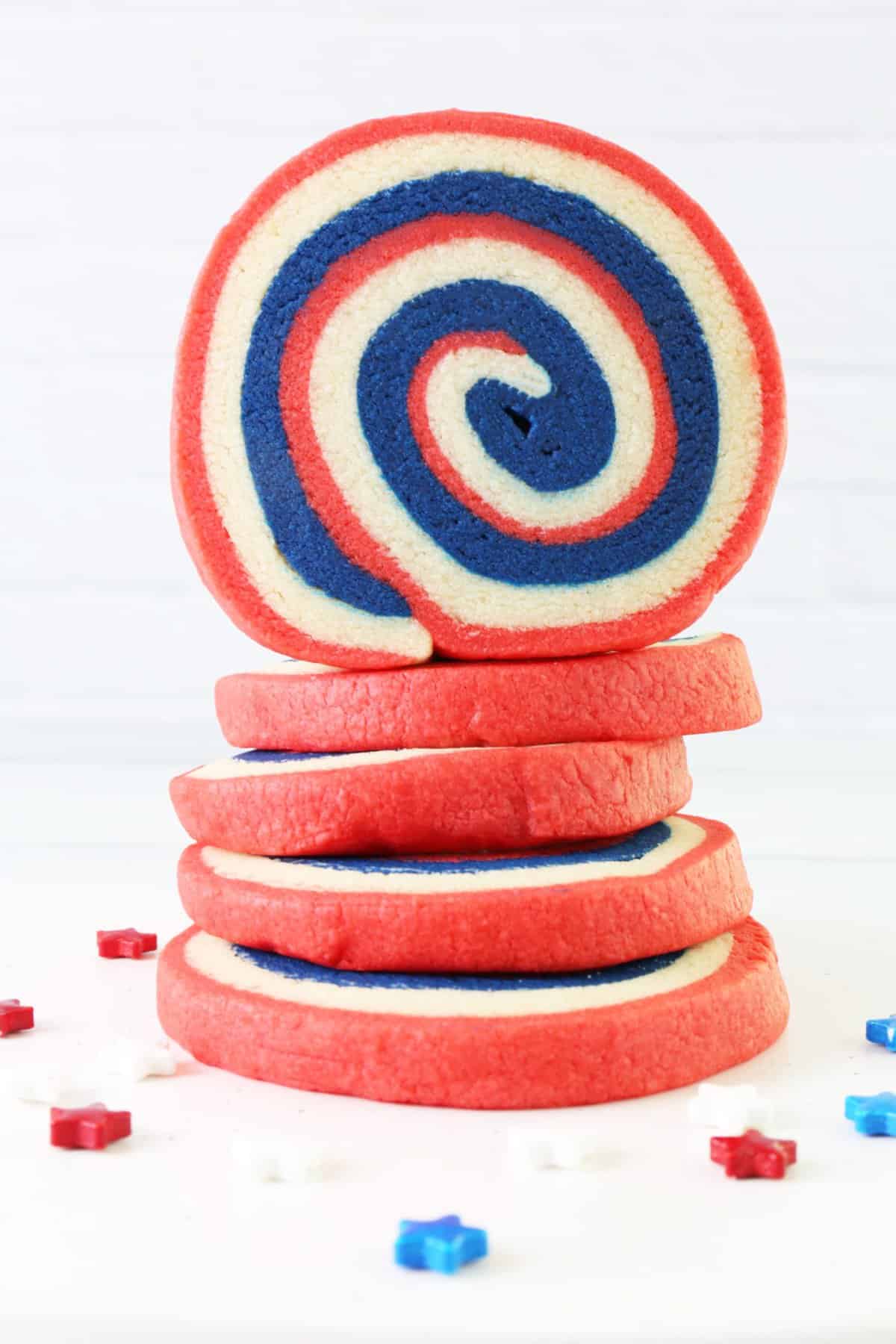 Stacked pinwheel cookies with top cookie standing up to show the layers.