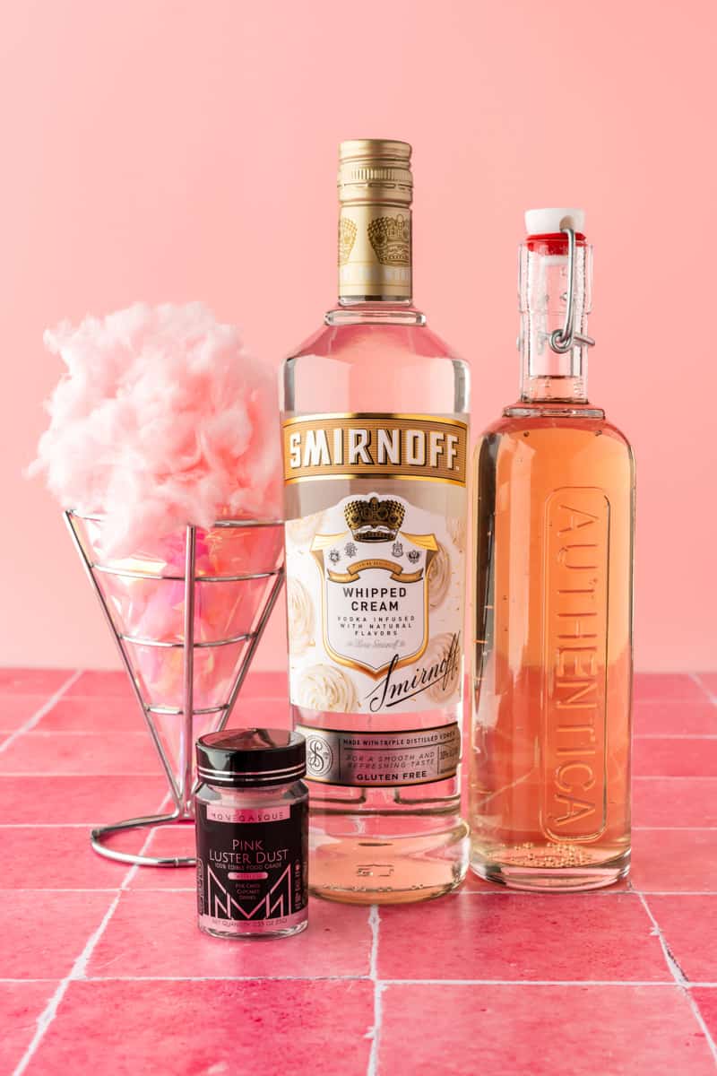 Ingredients to make the cotton candy drink on pink background. 