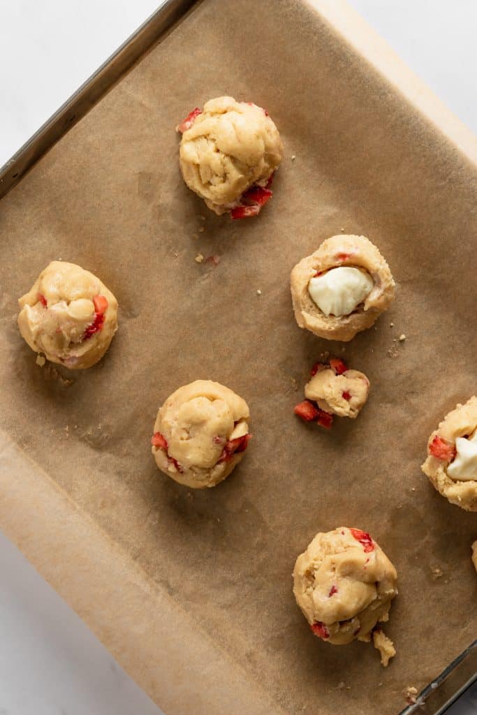 Cream cheese ball added to the center of each cookie dough round. 