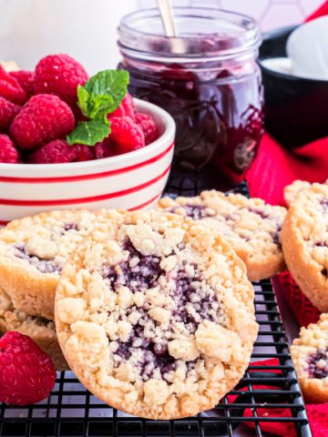 Feature image of the raspberry cookies from Costco on wire rack with fresh berries.