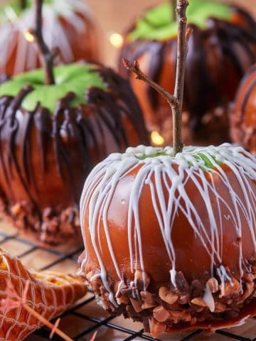 Square image of the gourmet caramel apples with toffee bits and chocolate drizzle.