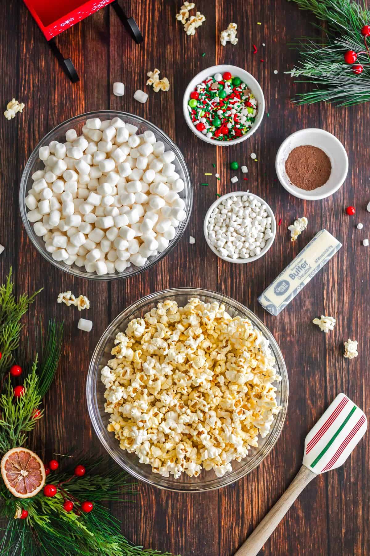 Ingredients to make the hot chocolate popcorn balls on a wood background. 
