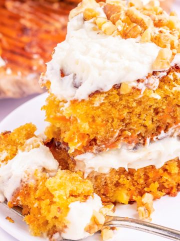 Feature image of a slice of carrot cake with a bite taken out of it.