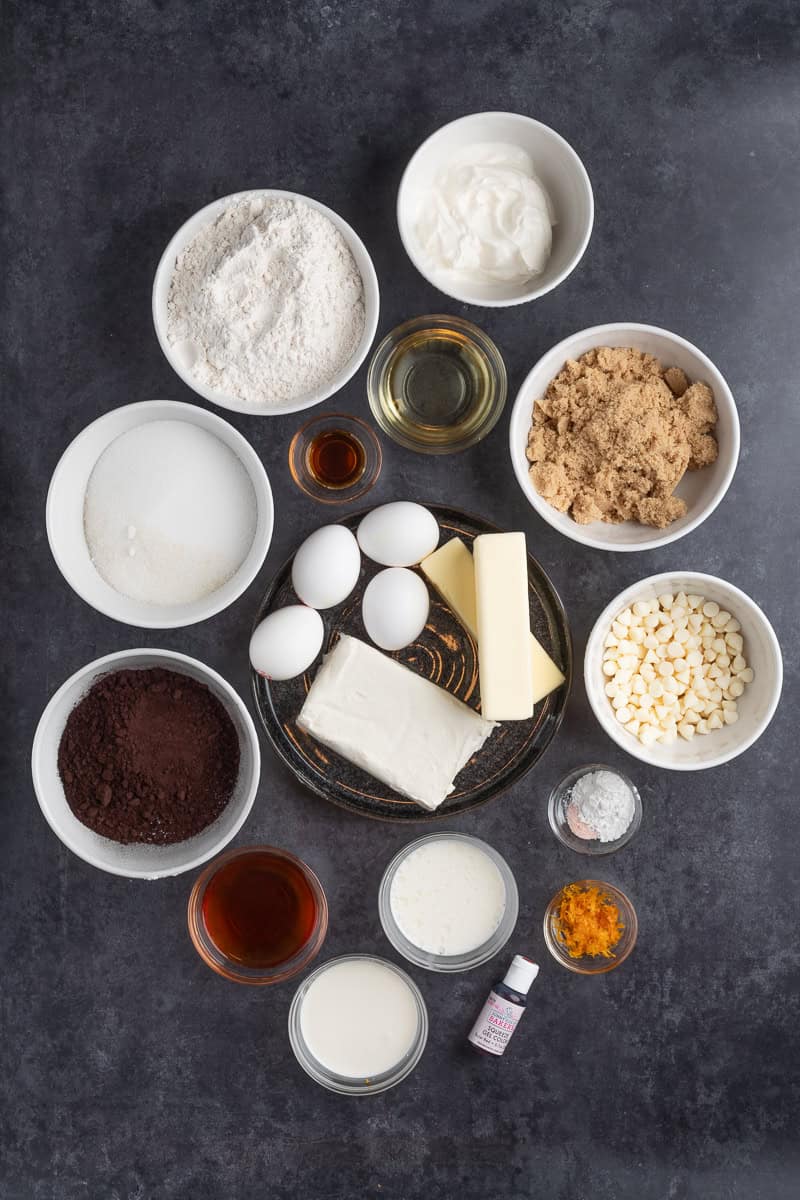 Overhead shot of the ingredients to make the black bundt cake in small white bowls. 