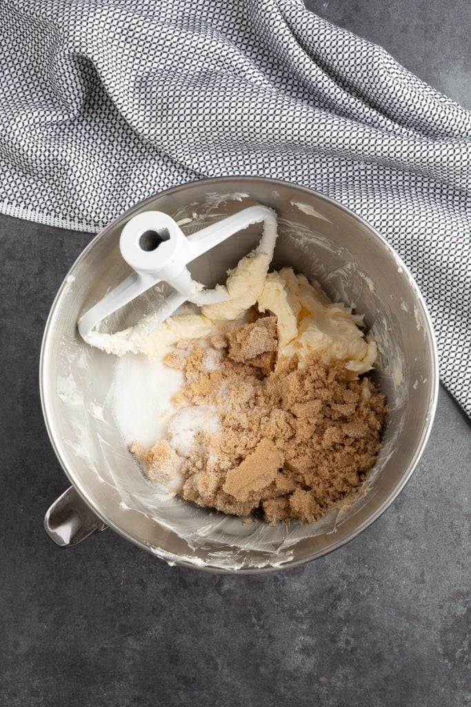 Overhead shot of mixing bowl with creamed butter and brown sugar and white sugar. 